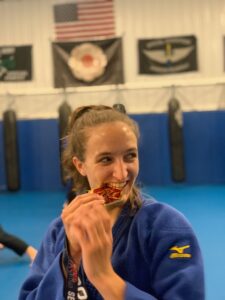 Brinna Lavelle bites medal